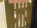 Close up of gate (open picket style) built from pressure treated lumber to protect sublevel entrance for basement stairs at home on Seminary Road, Silver Spring, MD.