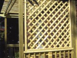 Close up of lattice work on right side of trellis style covered porch made of pressure treated lumber for kitchen exterior entrance at home on University Boulevard, Silver Spring, MD.