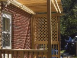 Side view of trellis style porch made of pressure treated lumber for kitchen exterior entrance at home on University Boulevard, Silver Spring, MD.