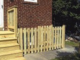 Spaced picket style fence surrounding basement stairs leading to below ground entrance at home on Seminary Road, Silver Spring, MD.