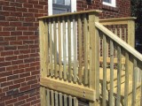 Side view of exterior stairs with close up view of deck railing made of pressure treated lumber at home on Seminary Road, Silver Spring, MD 