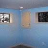 Finished wall and electrical panel cabinet door (existing casement windows still to be replaced) in basement remodel  of home on Bradley Boulevard in Bethesda, MD.